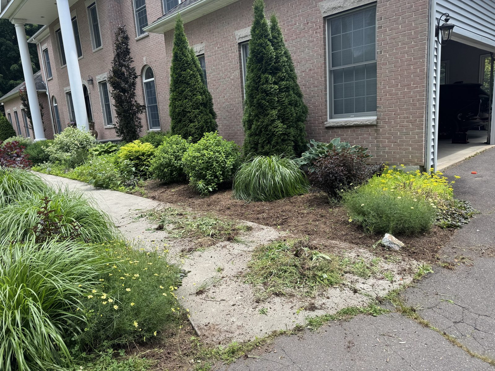 Planting beds edged and cleaned along a brick home