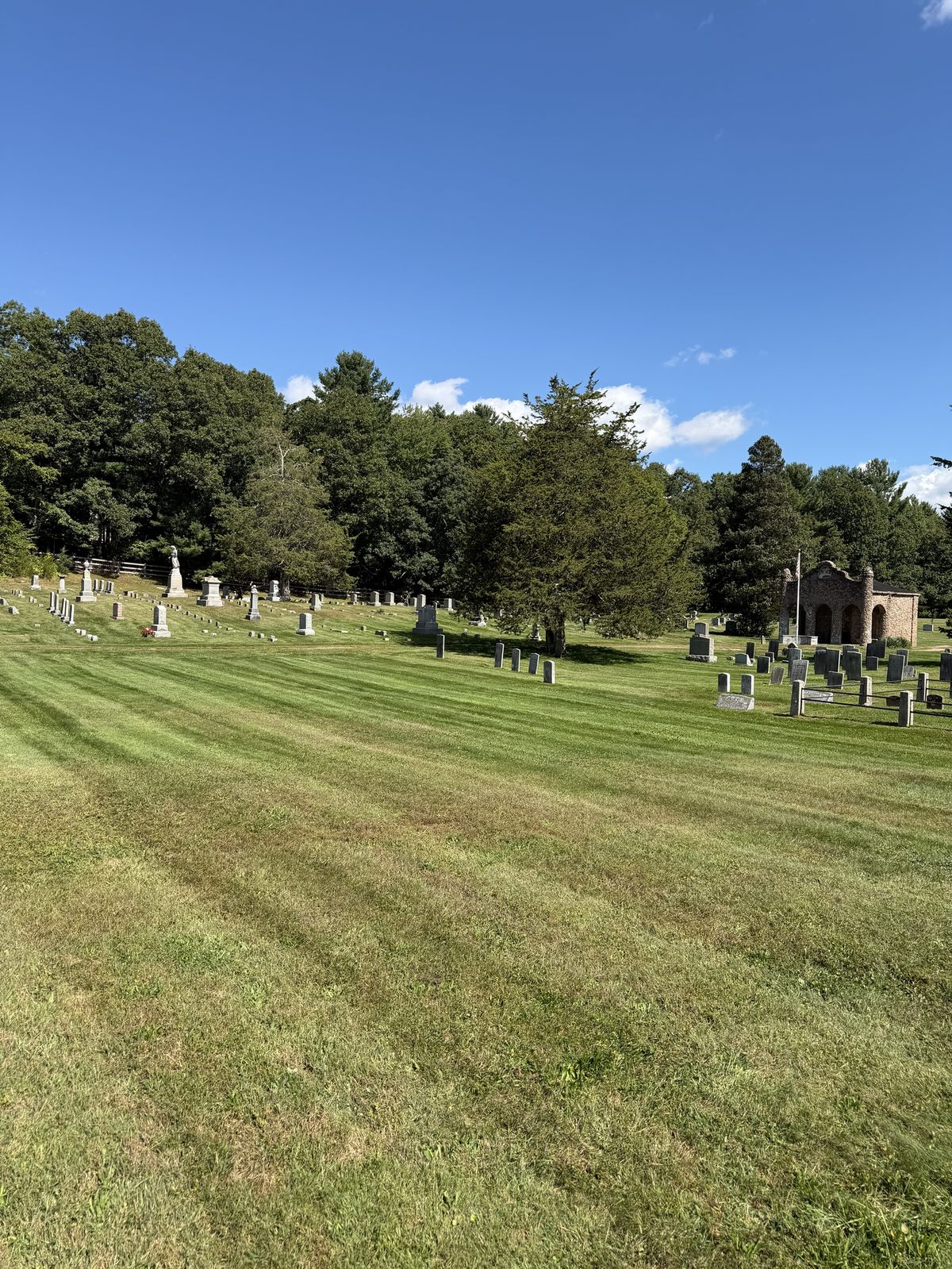 Large mowed cemetery lawn with even stripes