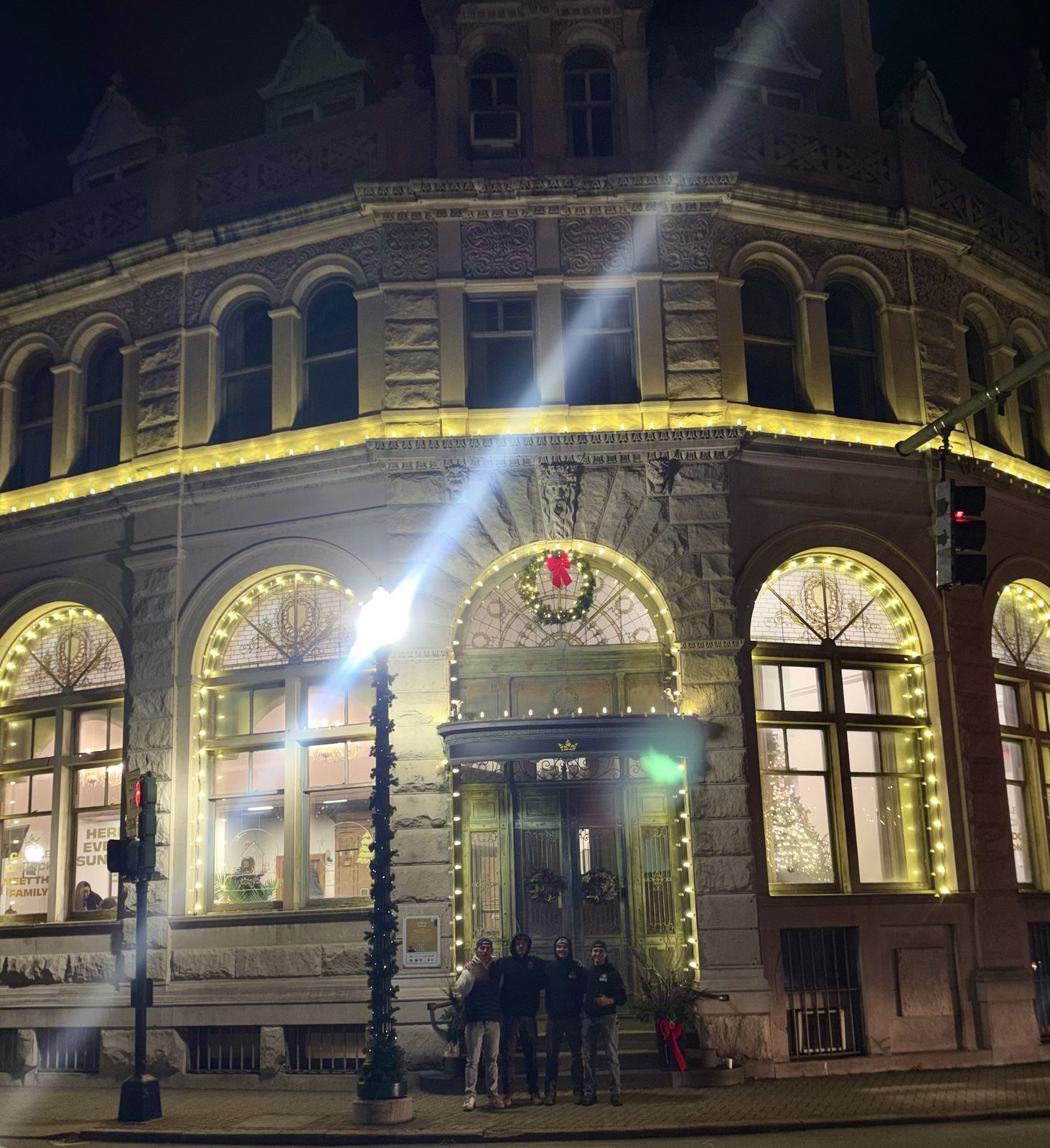 The crew in front of a historic downtown building they lit