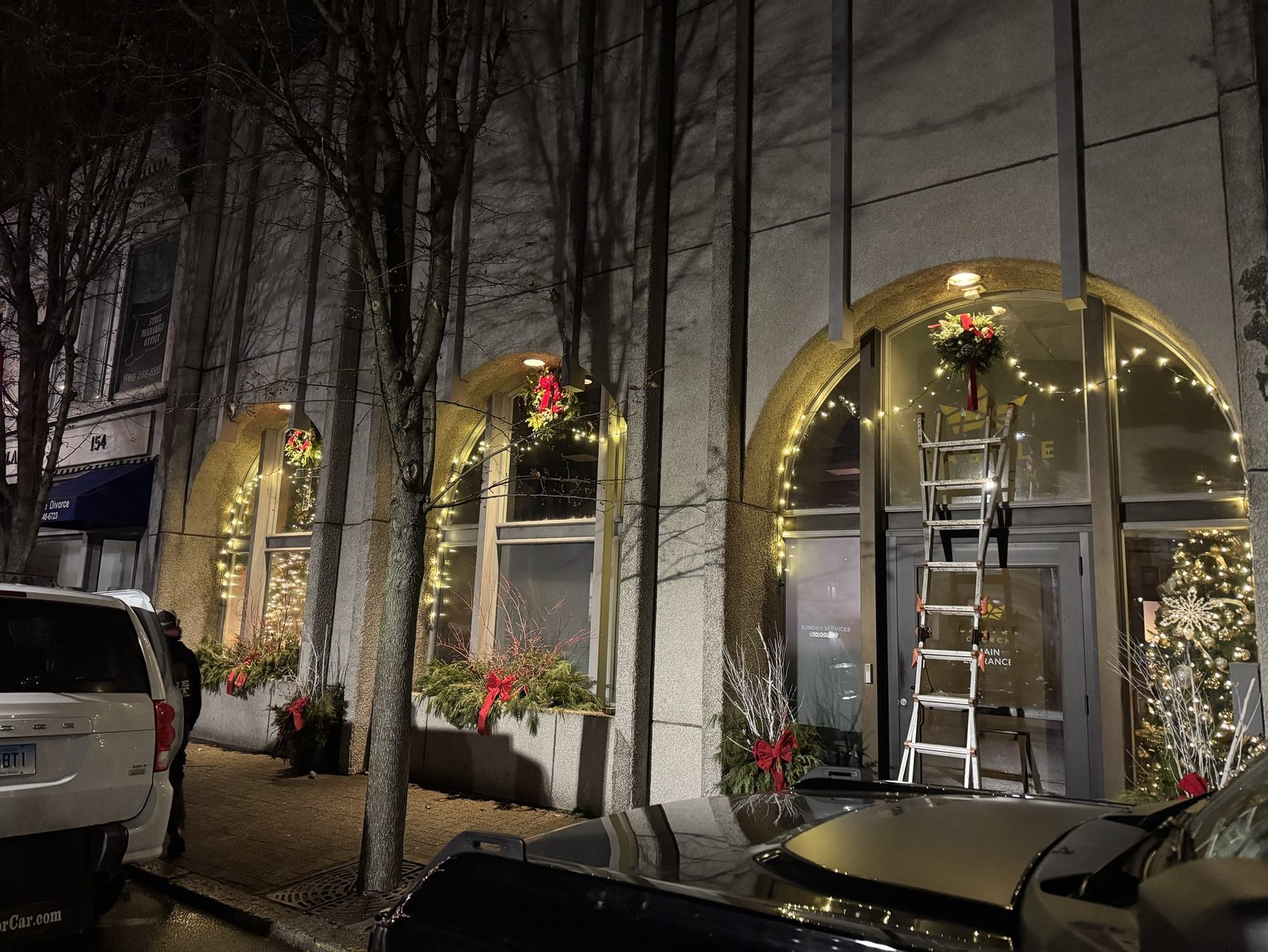Downtown storefront arches outlined with lights and wreaths